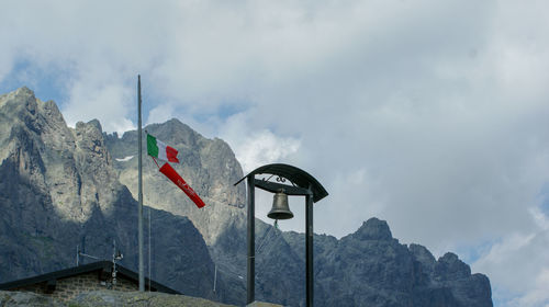 Low angle view of flag against mountain range