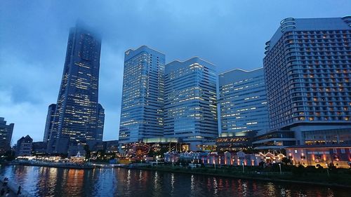 Low angle view of illuminated cityscape against sky