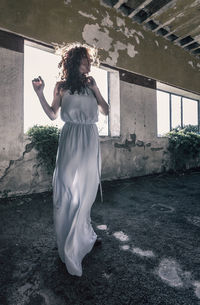 Beautiful fairy actress standing in front of the window