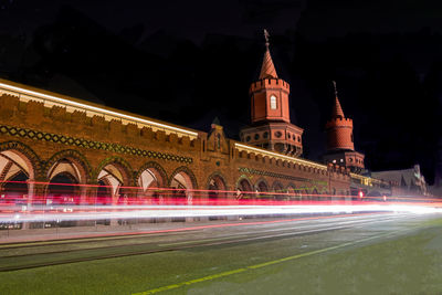 Light trails at oberbaum bridge against sky