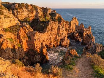 Panoramic view of cliffs at ponta da piedade during sunset