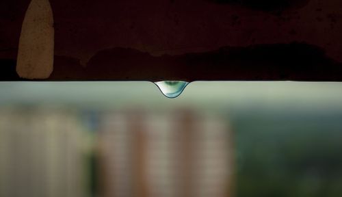 Close-up of water drop against sky