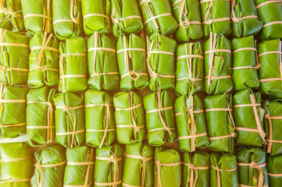 Full frame shot of food wrapped in banana leaves for sale at market stall