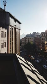 View of city street and buildings against sky