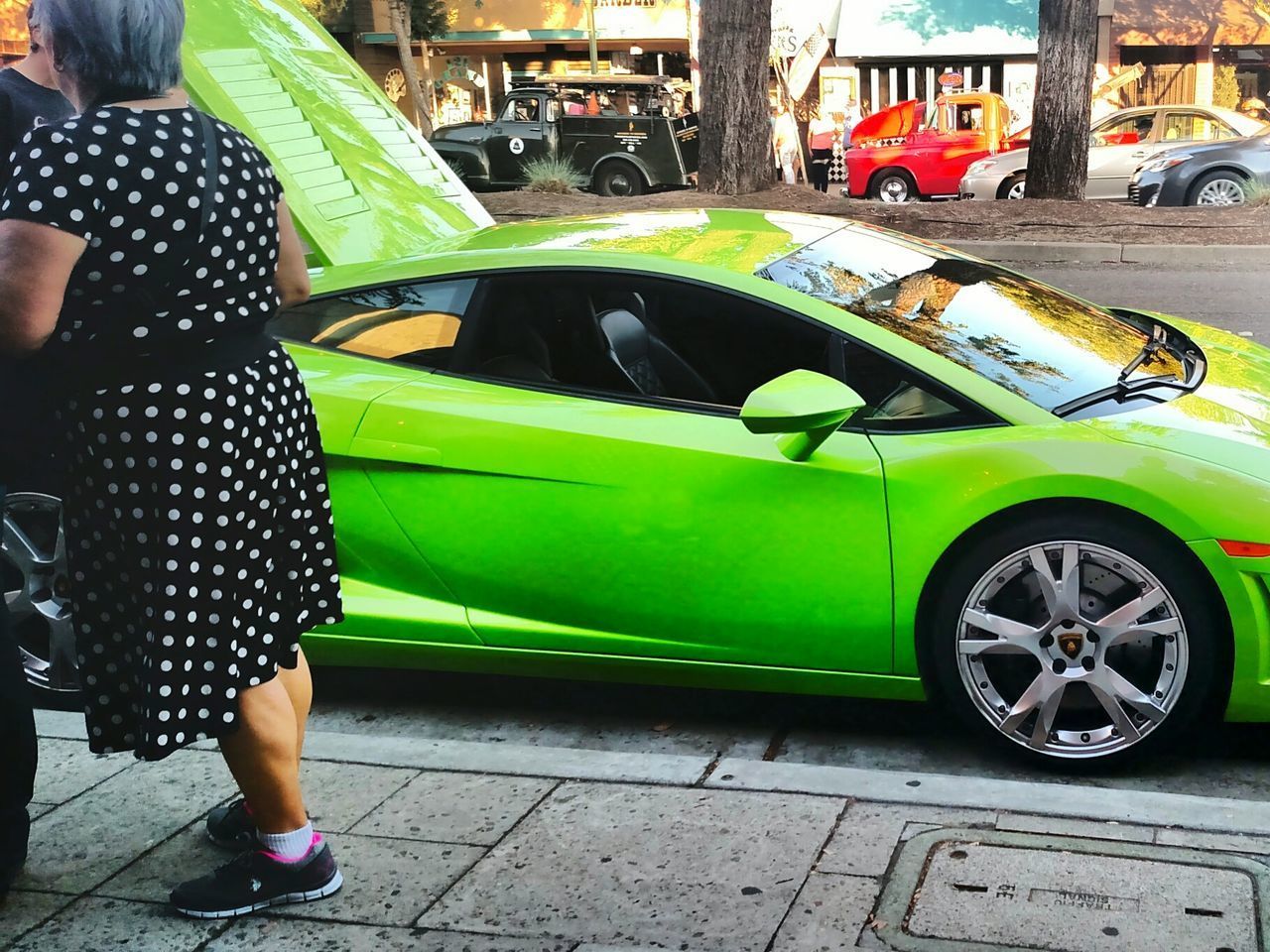 LOW SECTION OF MAN STANDING BY CAR ON STREET