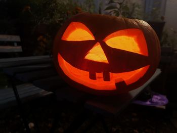 Close-up of illuminated pumpkin on table during halloween