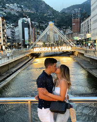 Full length of couple standing on bridge