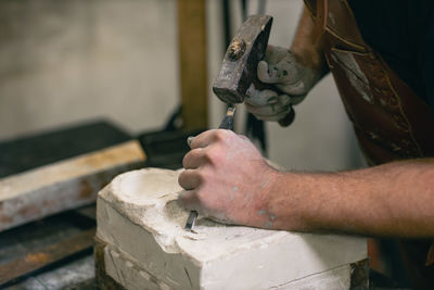 Midsection of man working in workshop