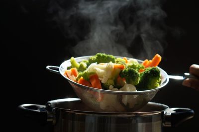 Steaming of hot boiled vegetables. basket of vegetables that just boiled from hot water with steam 