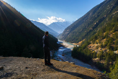 Rear view of man standing on mountain