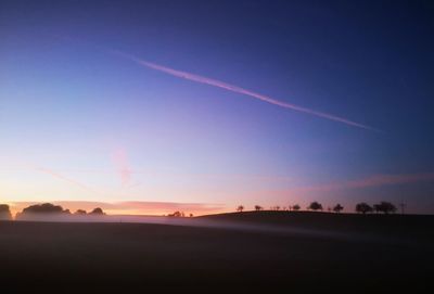 Scenic view of silhouette landscape against sky at sunset