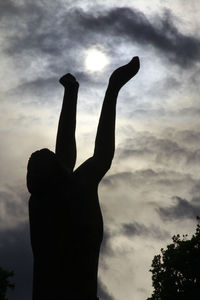 Low angle view of silhouette hand against sky during sunset