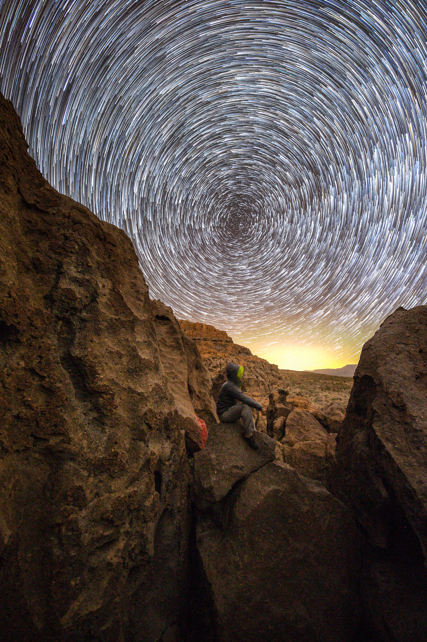 star - space, rock, nature, space, rock - object, solid, sky, rock formation, beauty in nature, astronomy, night, mountain, leisure activity, scenics - nature, adventure, tranquility, climbing, activity, one person, long exposure, outdoors