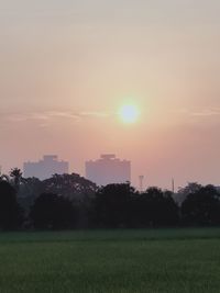 Scenic view of field against sky during sunset