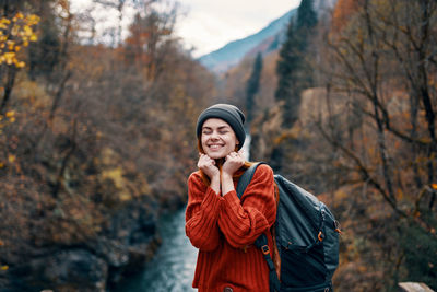 Young woman standing in park during autumn