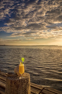 Yellow floating on sea against sky during sunset