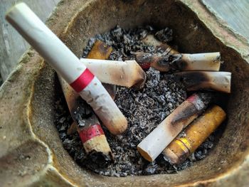 High angle view of cigarette on barbecue grill