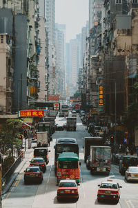 Traffic on city street by buildings