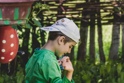 Side view of boy standing outdoors