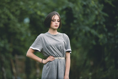 Full length of woman standing against tree