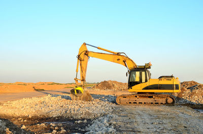 Crane at construction site against clear sky