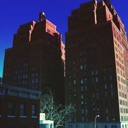 Low angle view of buildings against blue sky