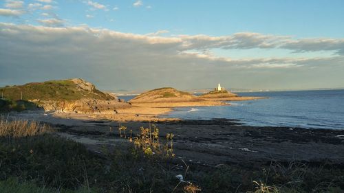 View of calm sea against cloudy sky