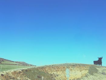 Scenic view of mountains against clear blue sky