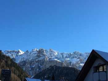 Scenic view of snowcapped mountains against clear blue sky