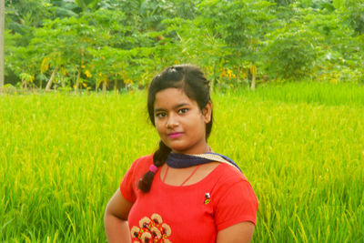 Portrait of beautiful young woman in field