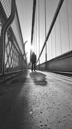 Rear view of people walking on footbridge