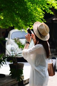 Midsection of woman photographing with mobile phone