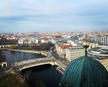 Aerial view of bridge over river and buildings in city