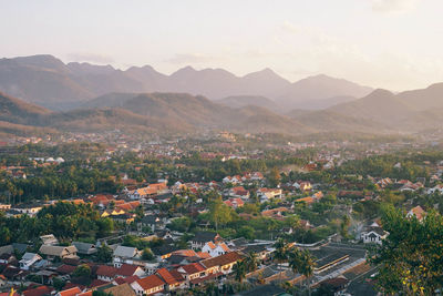 High angle view of townscape and mountains against sky