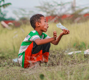 Side view of young woman drinking water