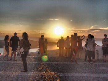 People on beach at sunset