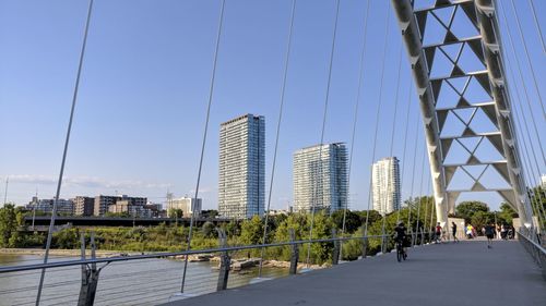 View of suspension bridge with city in background