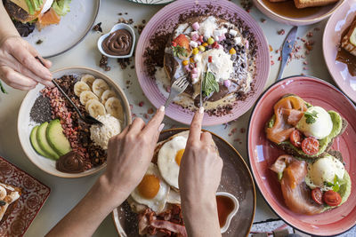 Breakfast is served with various dishes including eggs, bacon, pancakes and fruits 