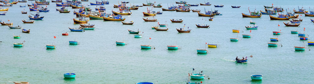 Panoramic view of boats moored in sea