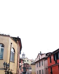 Low angle view of houses against clear sky