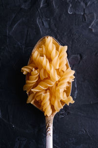 High angle view of yellow and orange leaf on black background