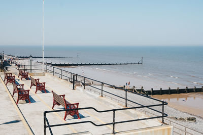 High angle view of chairs on beach against clear sky, cromer, norfolk, uk.