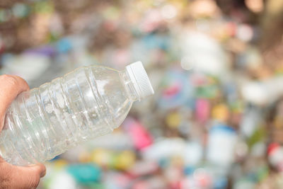 Close-up of hand holding bottle