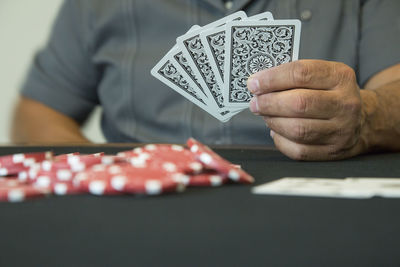 Close-up of man playing guitar on table