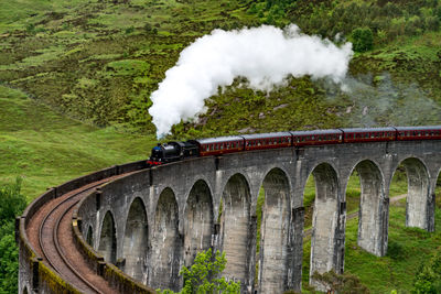 Jacobite steam train on glennfinnan viaduct