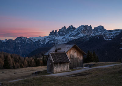 Scenic view of snowcapped mountains against sky during sunset