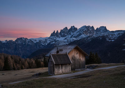 Scenic view of snowcapped mountains against sky during sunset