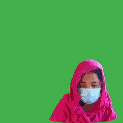 Portrait of woman with pink face against blue background