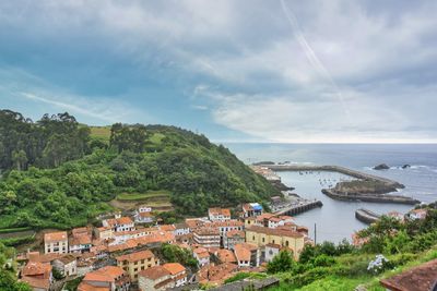 Townscape by sea against sky