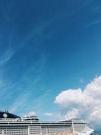 Low angle view of buildings against blue sky